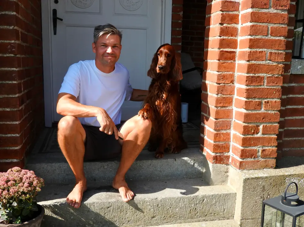 Anton with Taylor and our house in the Swedish countryside